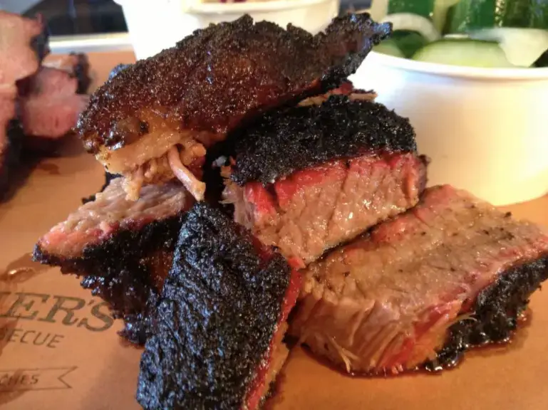 close up of bbq brisket sitting on a platter