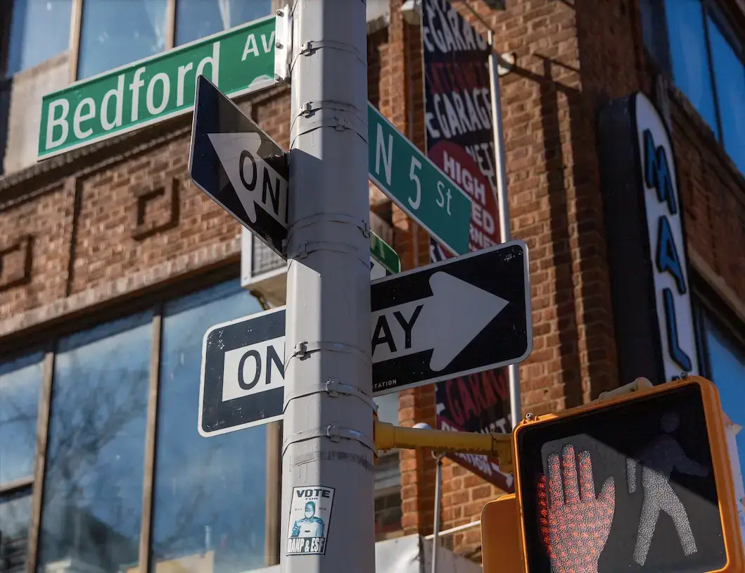 a close up of a street sign in front of a building