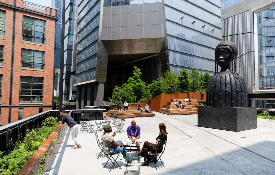a group of people riding horses on a city street