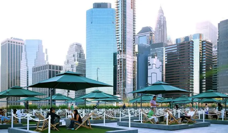 outdoor picnic area on a roof with NYC buildings in the background