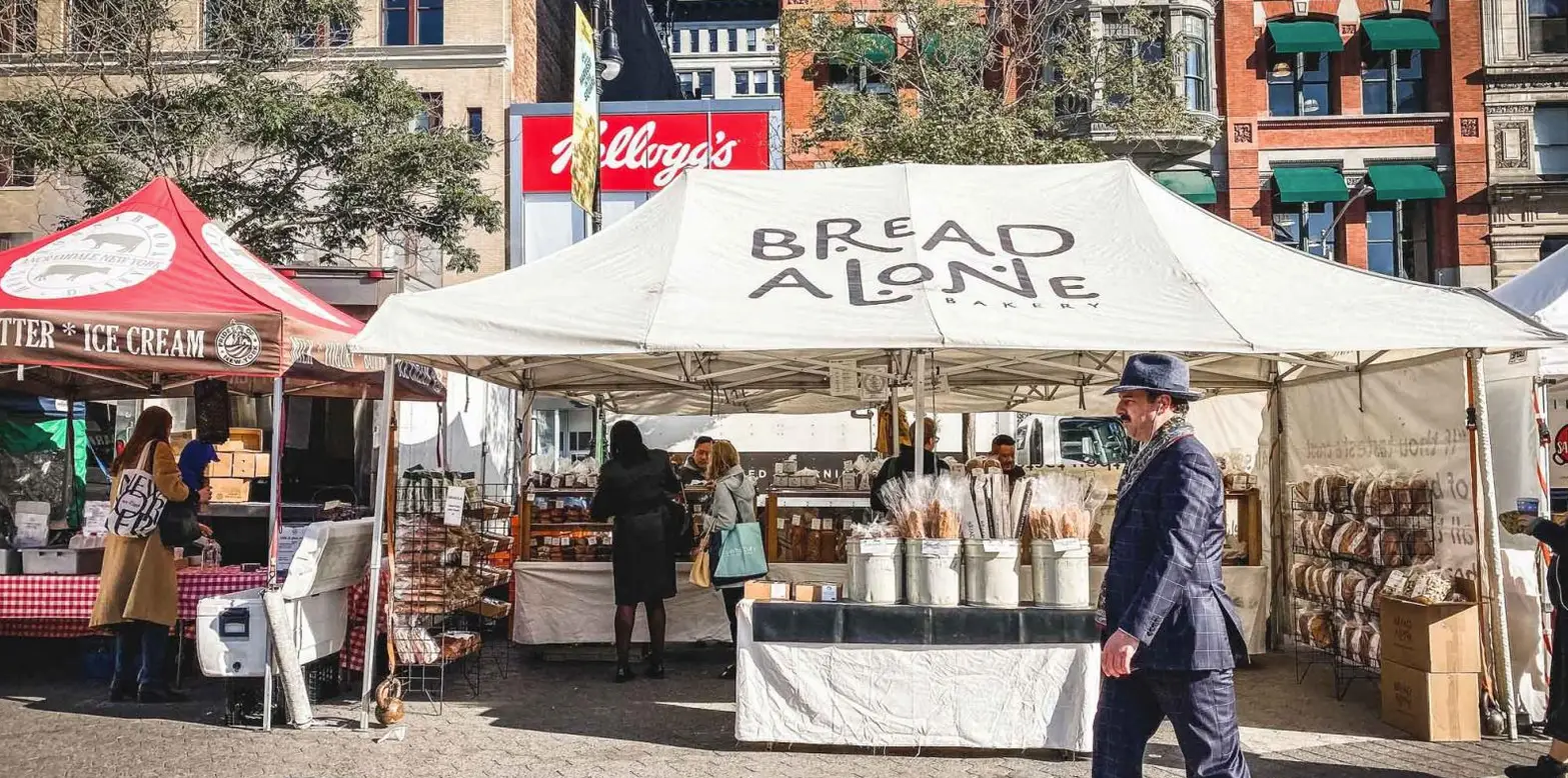 NYC's Best Markets: Food Markets, Flea Markets & More! | Like A Local Tours a group of people standing in front of a store