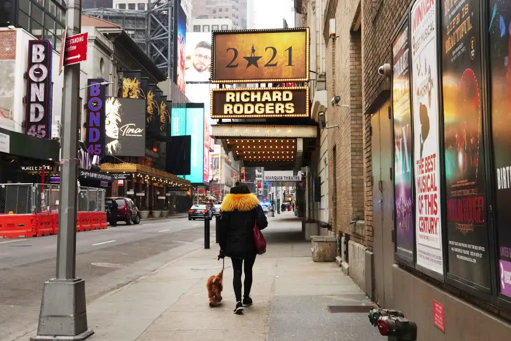 a person walking down the street in front of a store