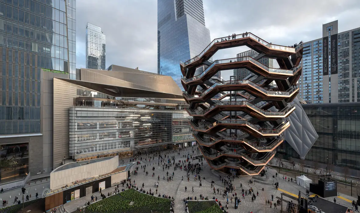 Our Chelsea Market and High Line Food Tour now includes Hudson Yards and Neuhaus Belgian Chocolate! | Like A Local Tours a tall sculptural building in new york city