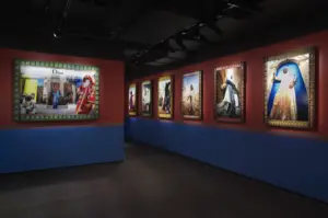 artworks hanging in a dark art gallery