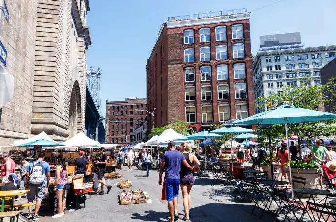 NYC's Best Markets: Food Markets, Flea Markets & More! | Like A Local Tours a group of people walking on a city street