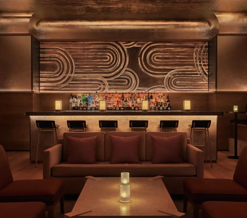an art deco gold bar with bar stools
