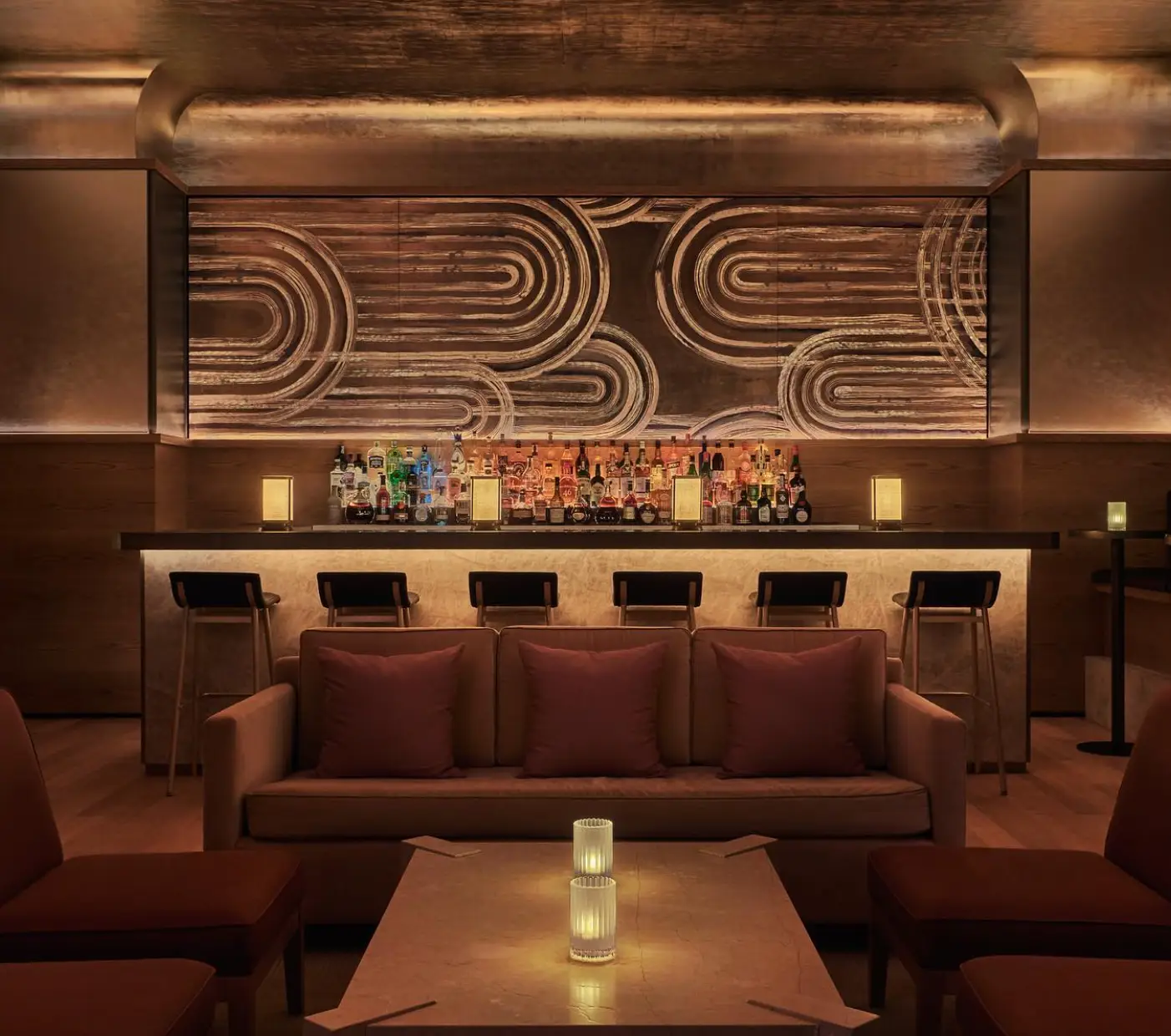 an art deco gold bar with bar stools
