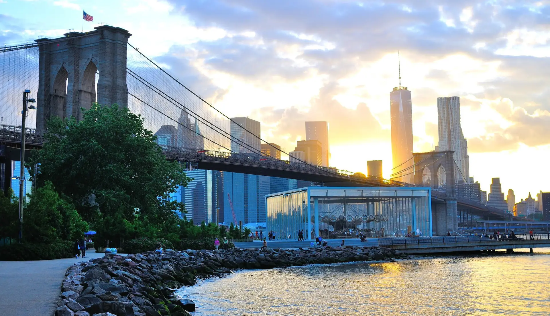 a bridge over a body of water with a city in the background