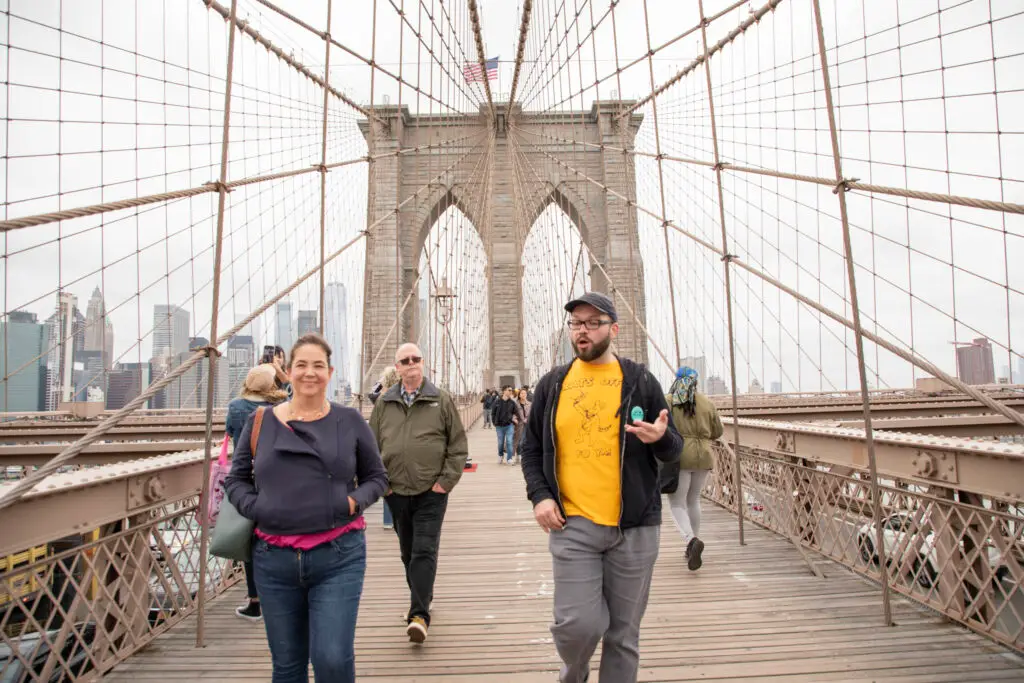 a group of people walking on a bridge