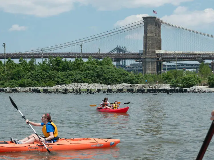 a group of people rowing a boat in the water
