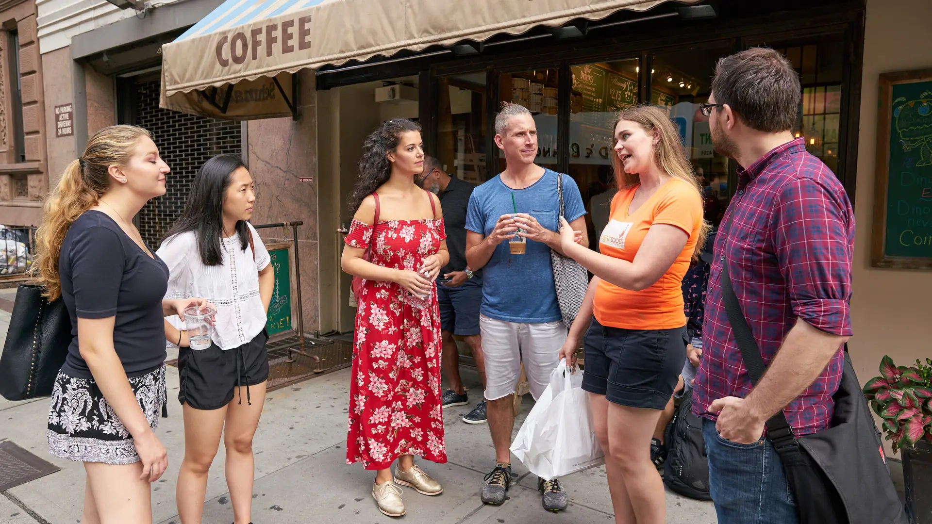 a group of people standing in front of a building