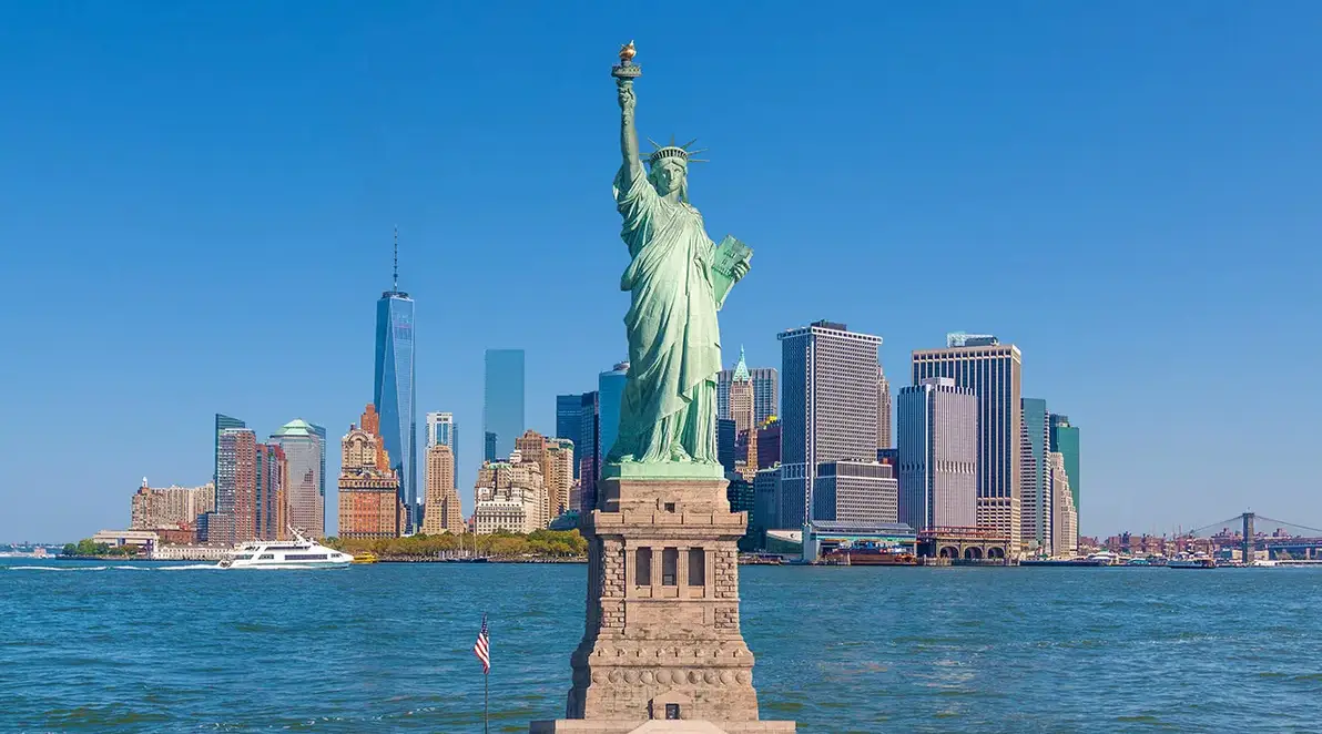 statue of liberty with lower manhattan buildings in the background