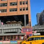 a taxi passing in front of a building