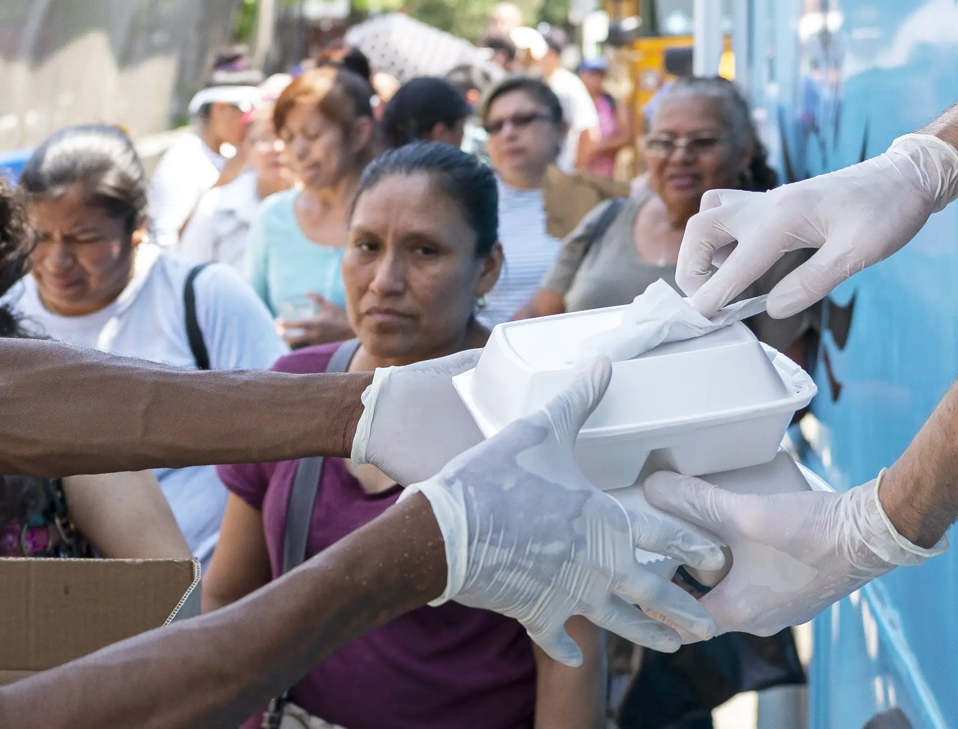 An Inside Look at Angels Cafe: Bagels, Giving Back and New York Spirit | Like A Local Tours a man standing in front of a crowd