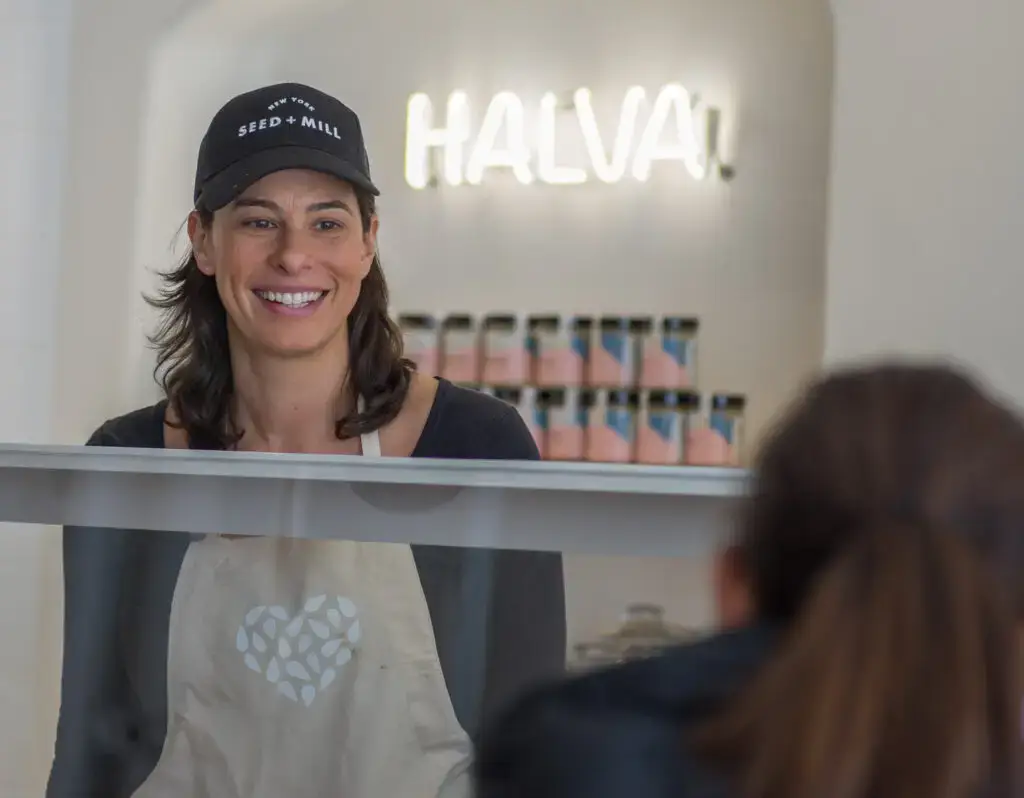 a woman standing in front of a mirror posing for the camera