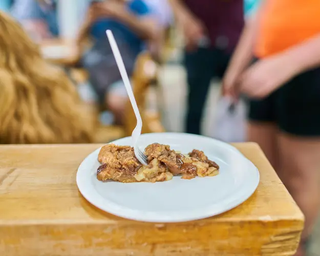 Finding Heaven in Hell's Kitchen on our Hell's Kitchen Tour | Like A Local Tours a woman sitting at a table with a plate of food