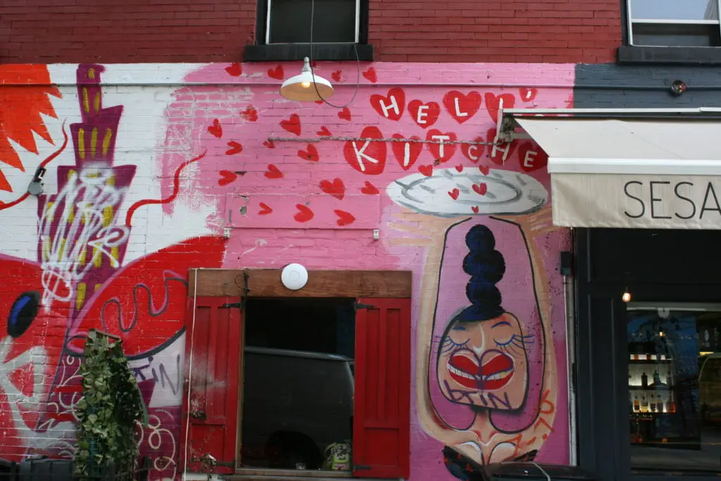 graffiti on a wall above a store