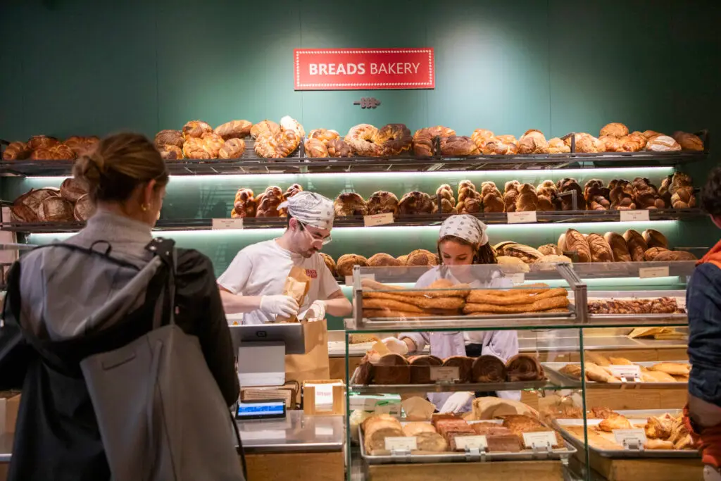 a group of people looking at a donut shop