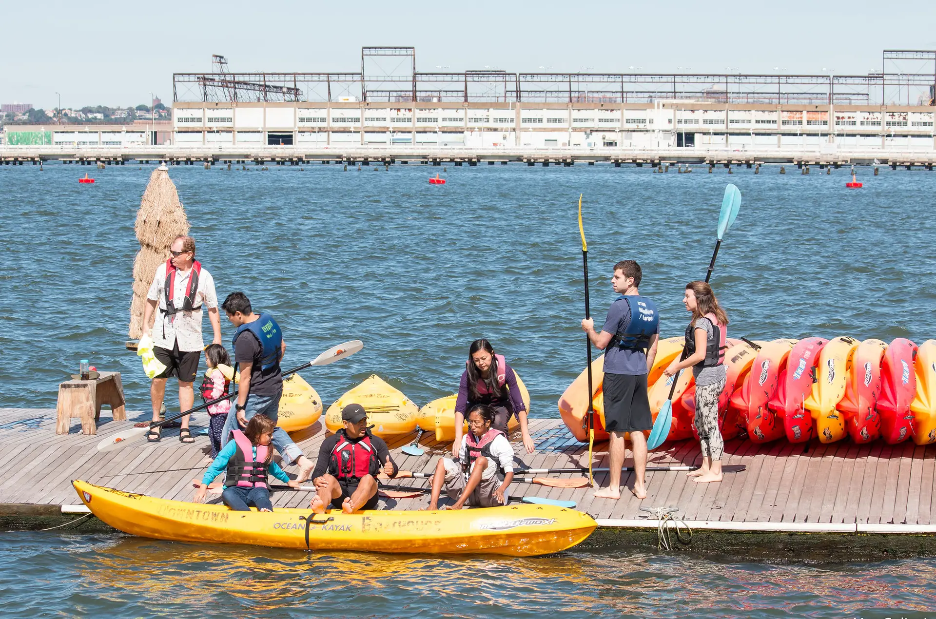 a group of people riding on the back of a boat in the water