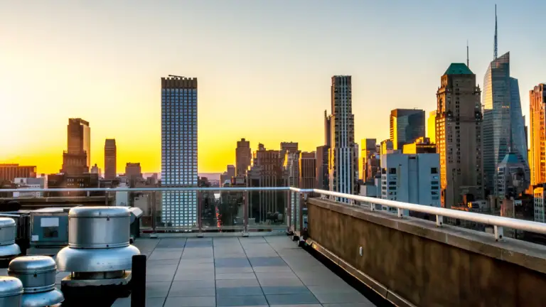 Rooftop terrace overlooking the Midtown Manhattan skyline at sunset