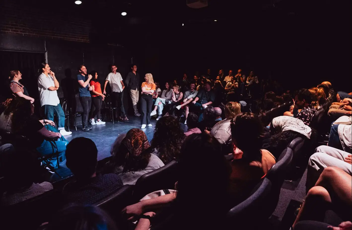 a group of people sitting in front of a crowd