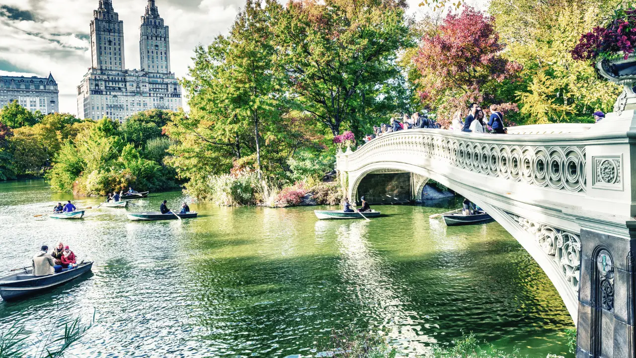 a boat traveling across a bridge over a river