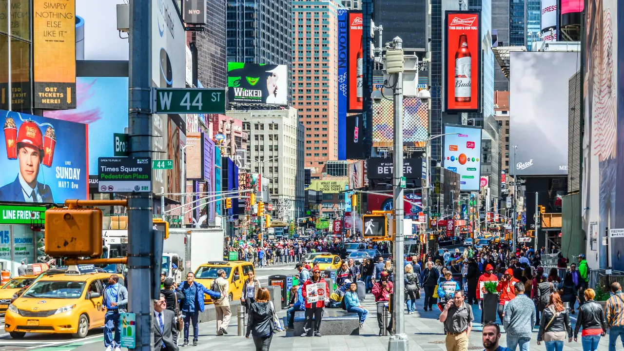 a group of people walking down a busy city street