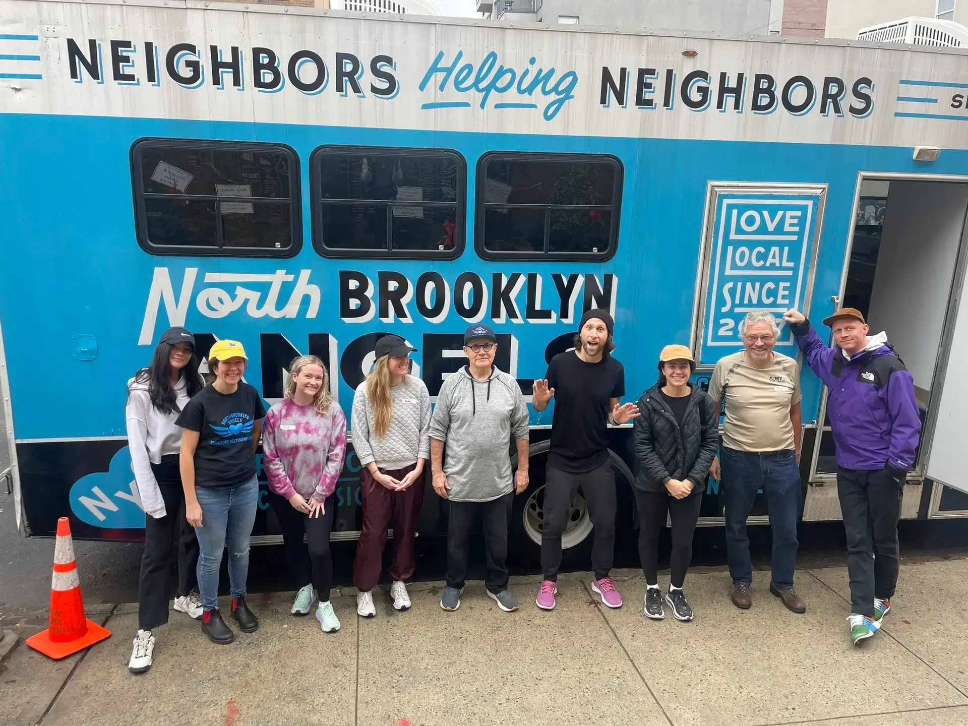 A group of people standing in front of a truck
