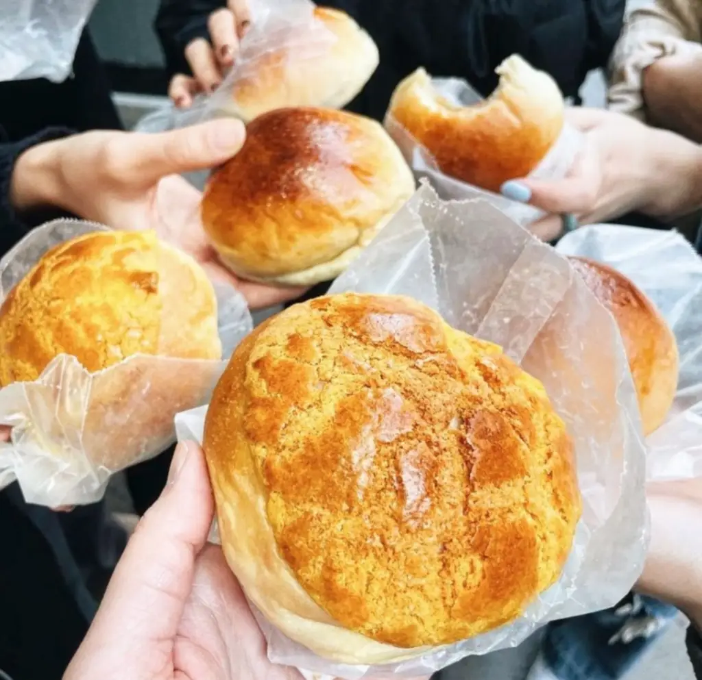 people holding pork buns