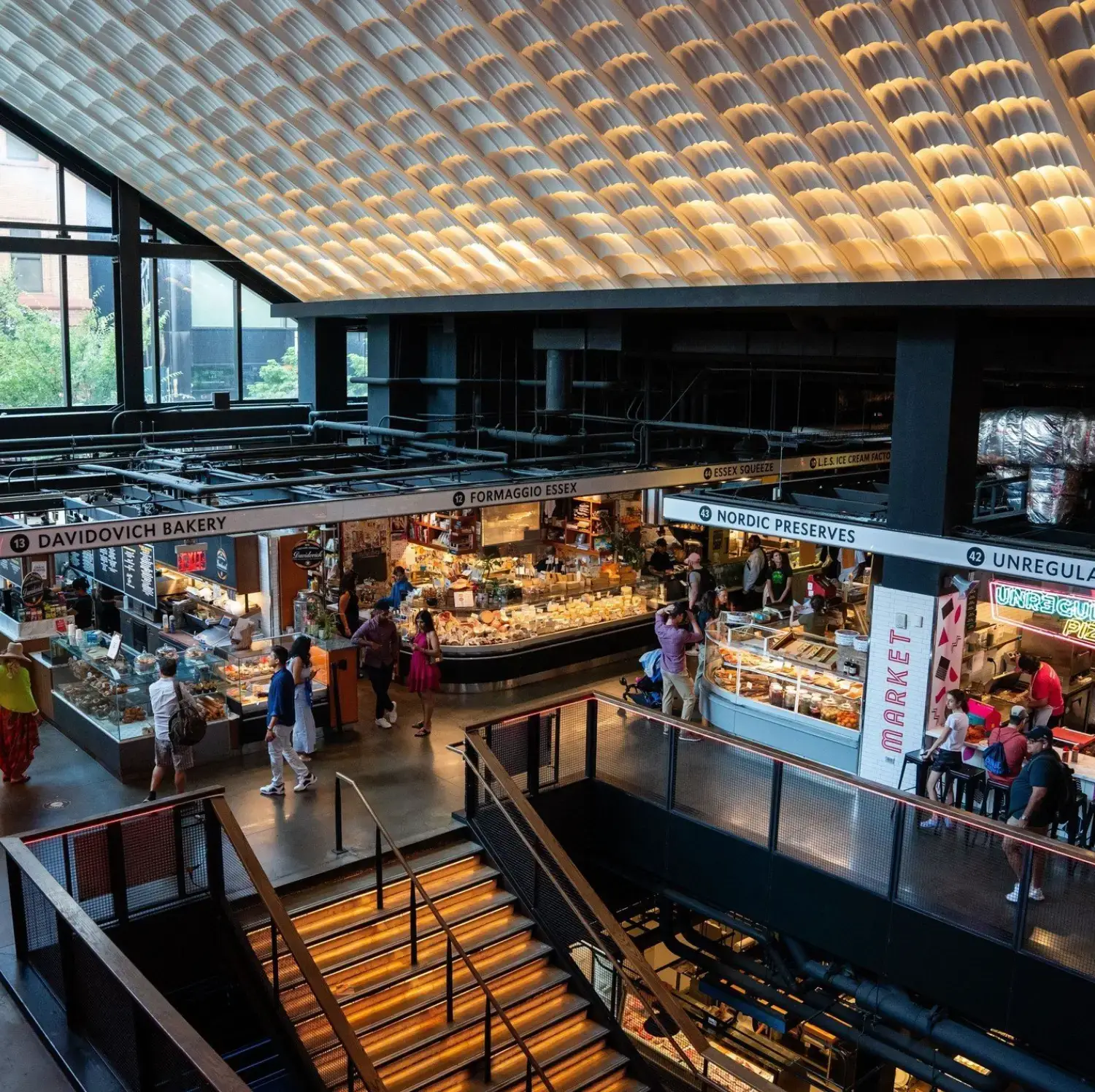 high ceiling with various vendors and people walking around