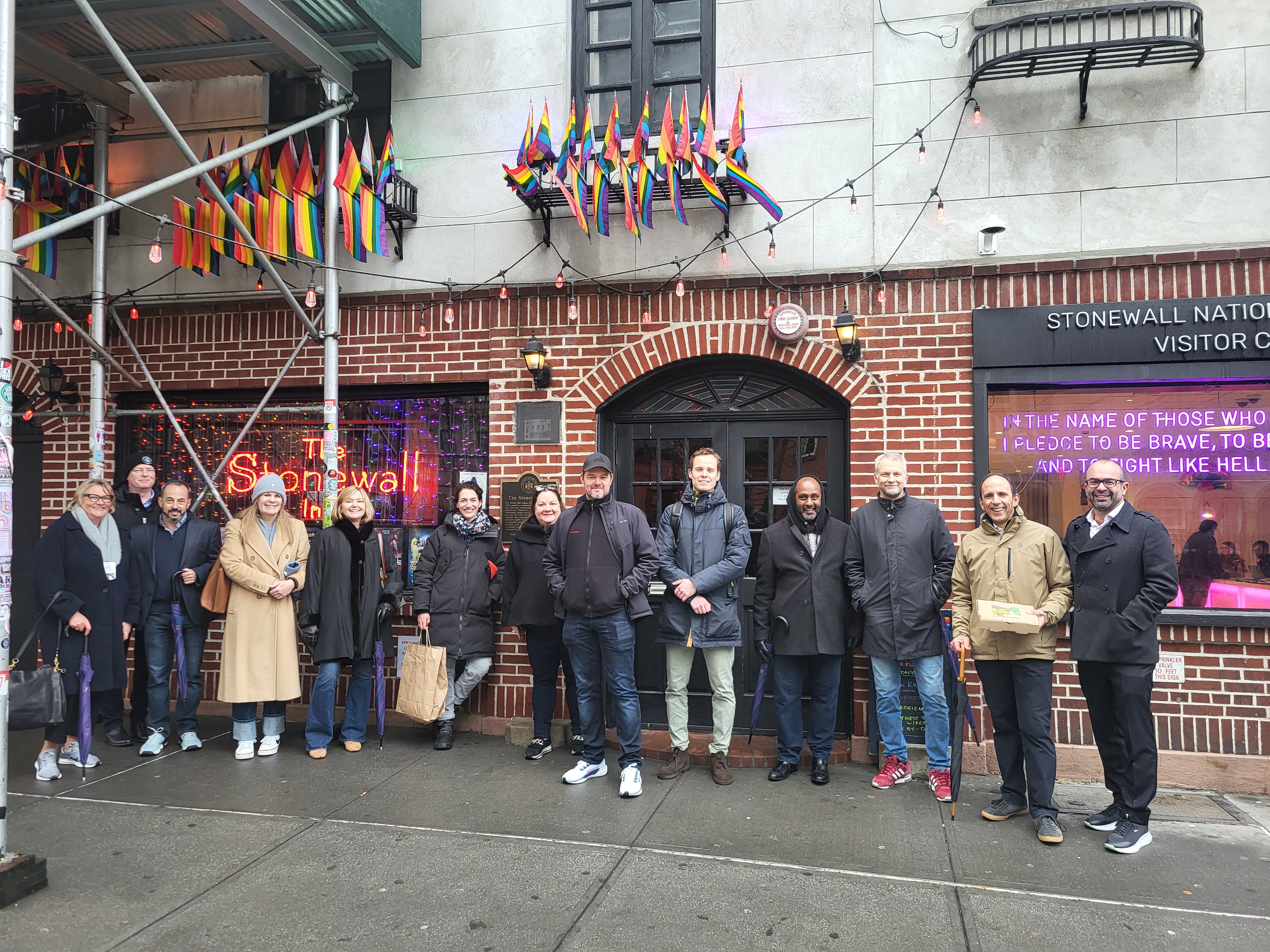 Group of people on a corporate food tour outside Stonewall Inn.
