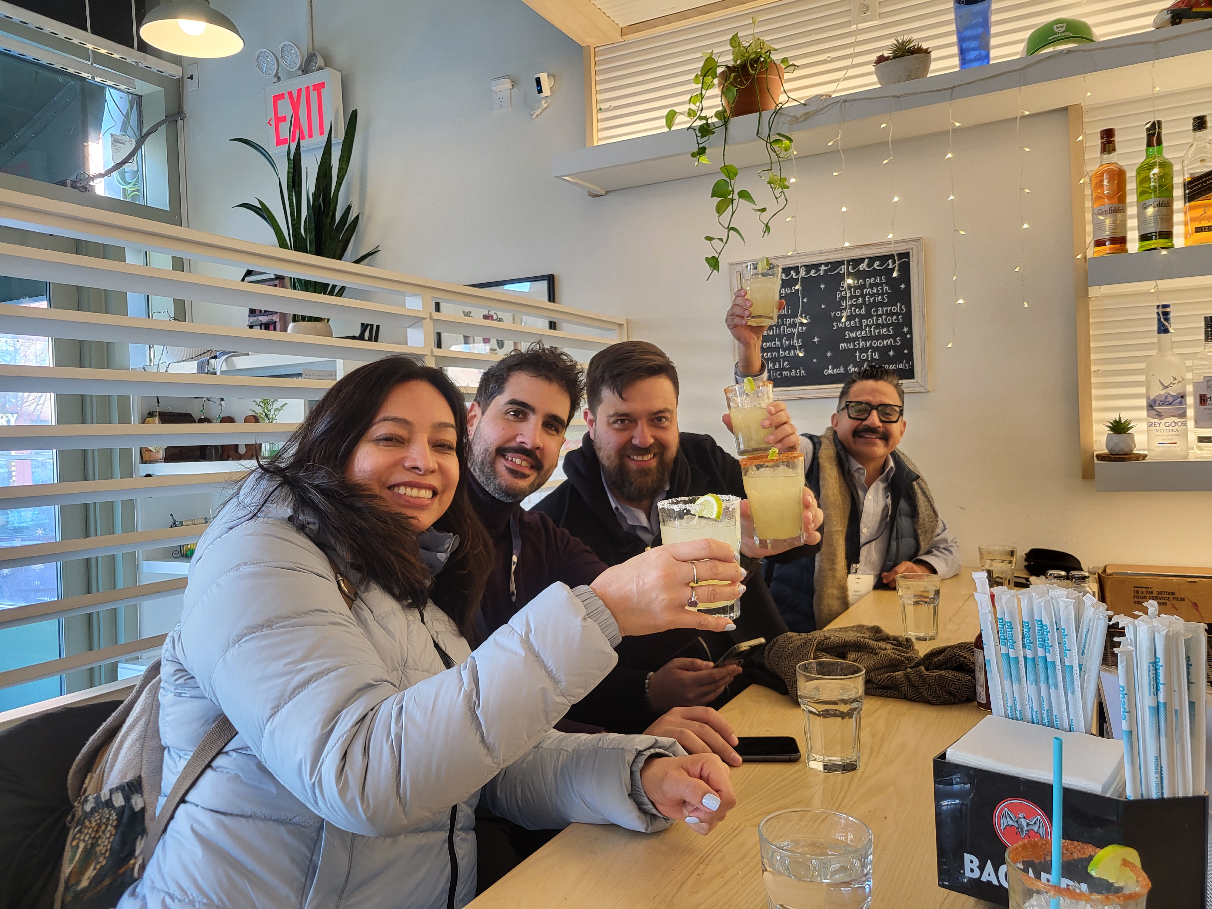a group of corporate people sitting at a table drinking together