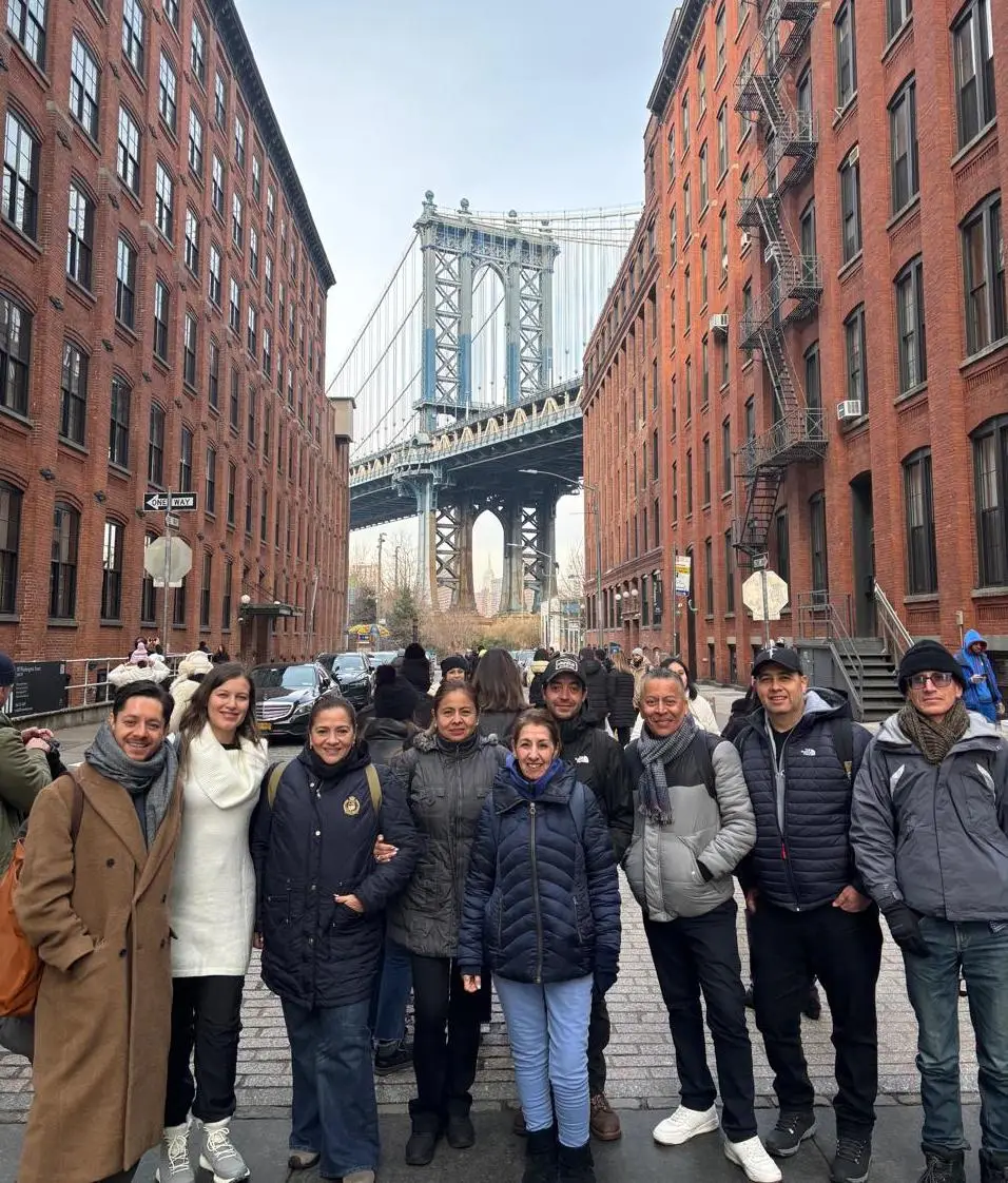 Group standing in front of the Manhattan Bridge on Water Street in DUMBO 