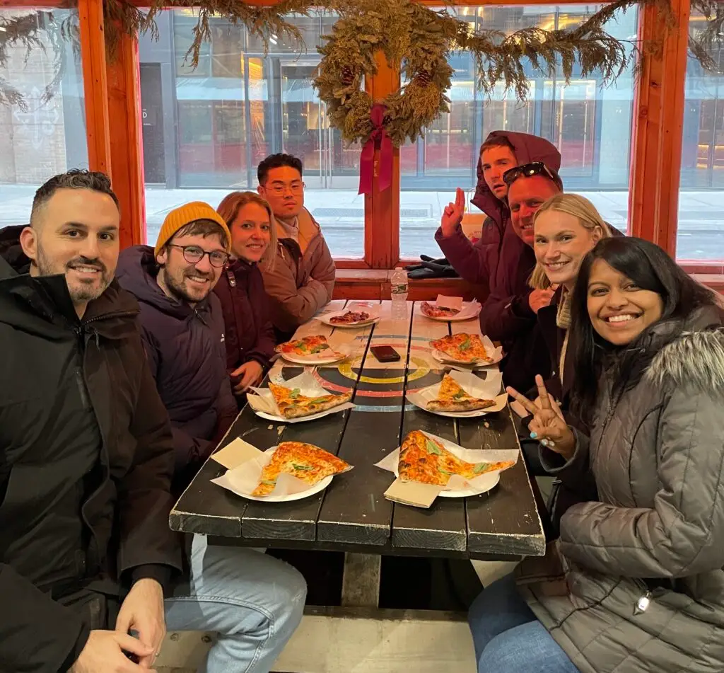 a group of people sitting at a table with food