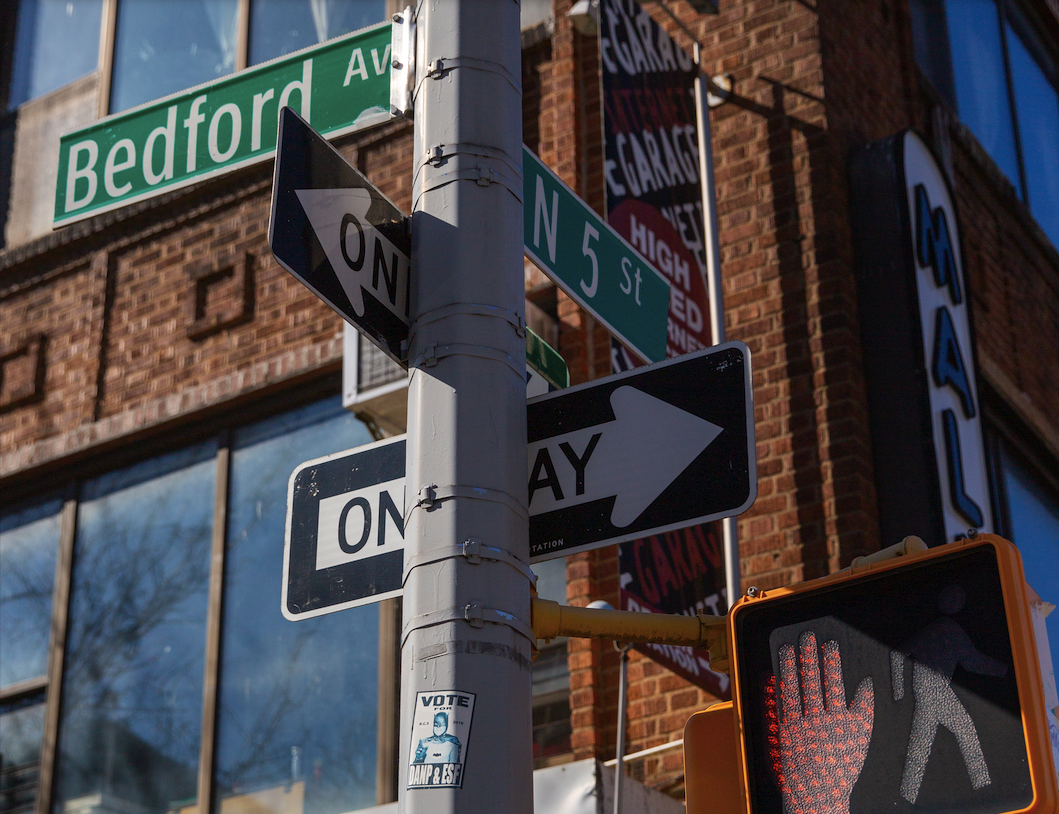 a close up of a street sign in front of a building
