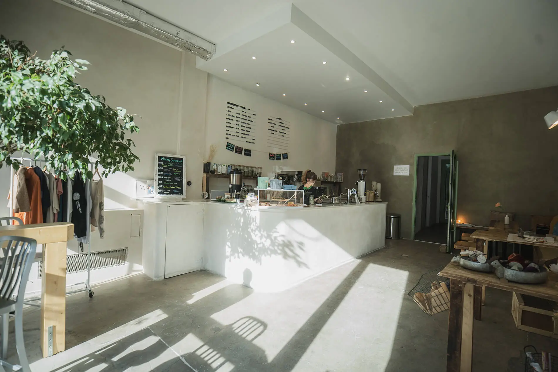 a cafe room filled with furniture and a large window