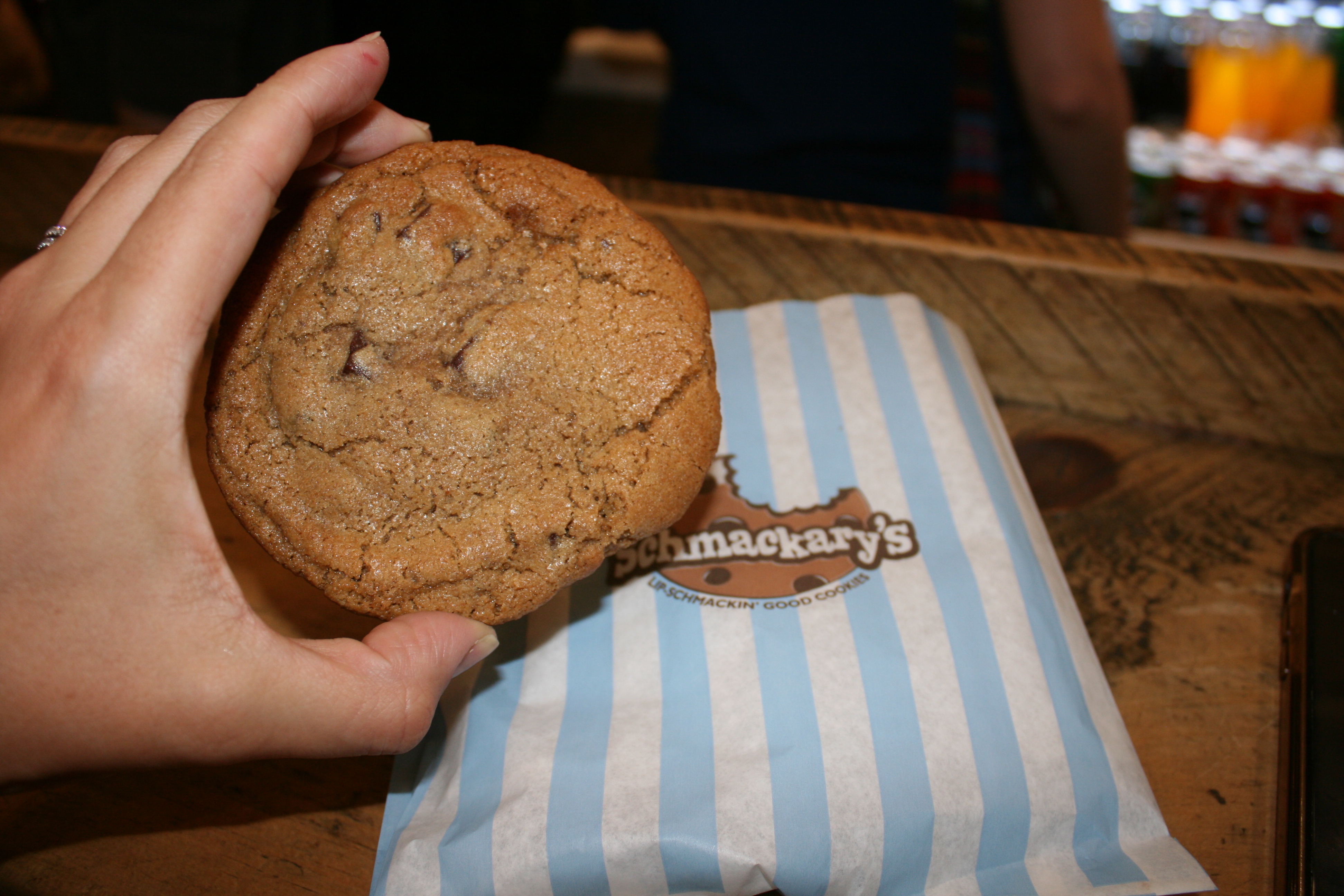 a close up of a person holding a cookie