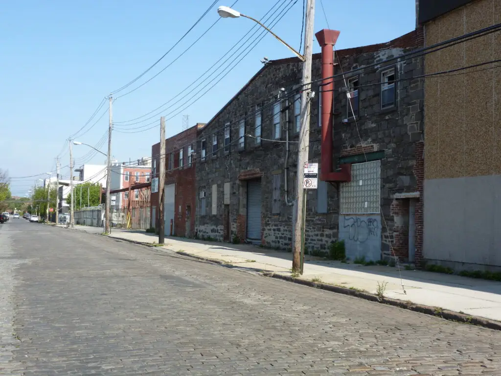 Historic Belgian-block cobblestone street lined with old warehouses in Red Hook, Brooklyn