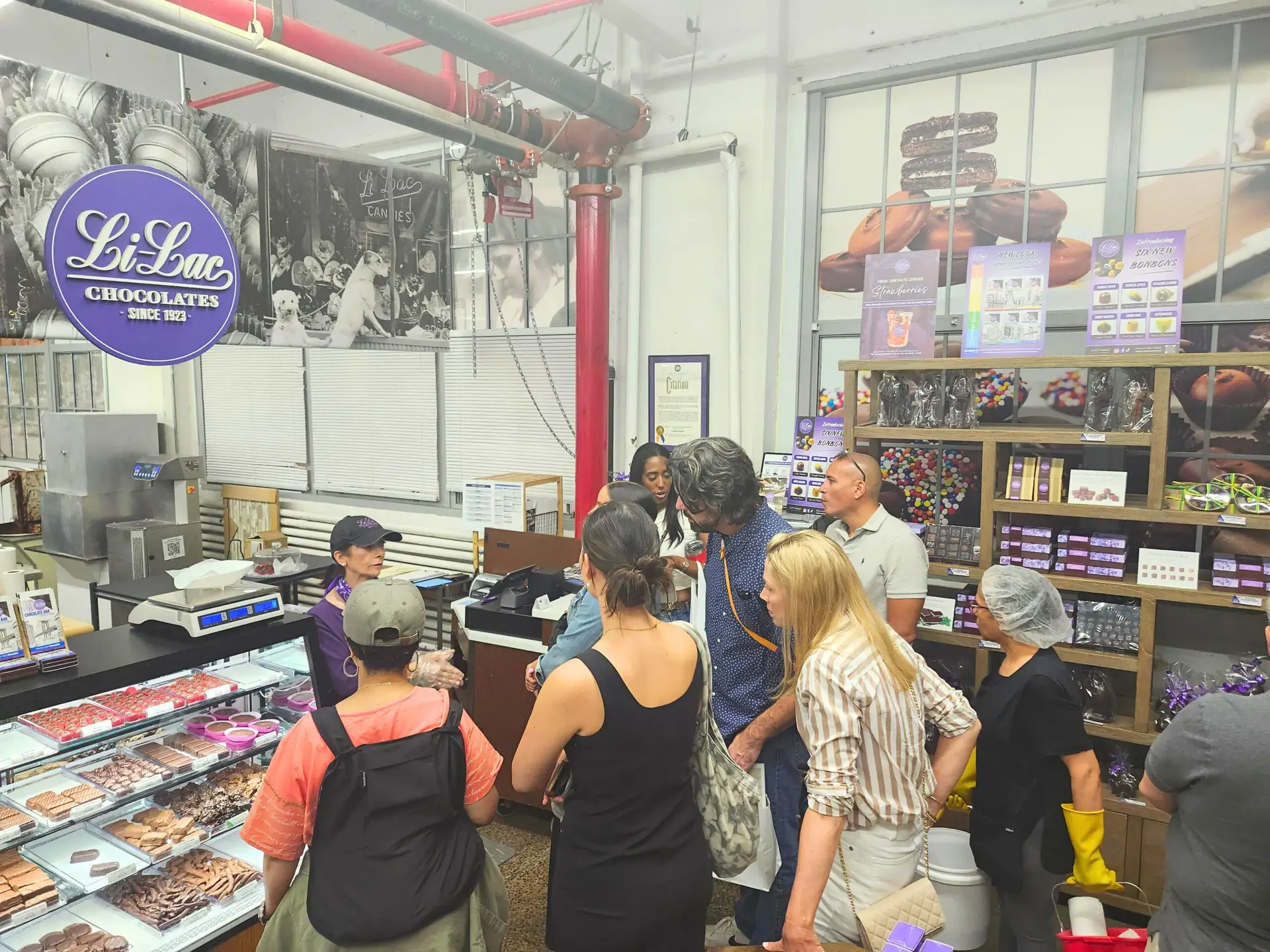 A group of people tour Li-Lac Chocolates at Industry City, Brooklyn.