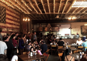 Inside Hometown Bar-B-Que in Red Hook, string lights and a vintage American flag