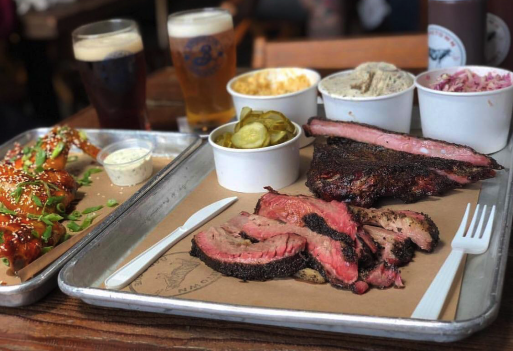 Platter of smoked brisket, ribs, wings and sides at Hometown Bar-B-Que in Red Hook