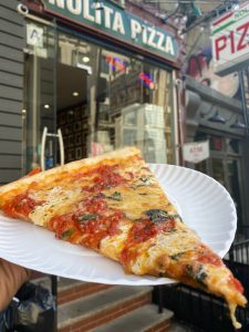 a slice of pizza on a paper plate