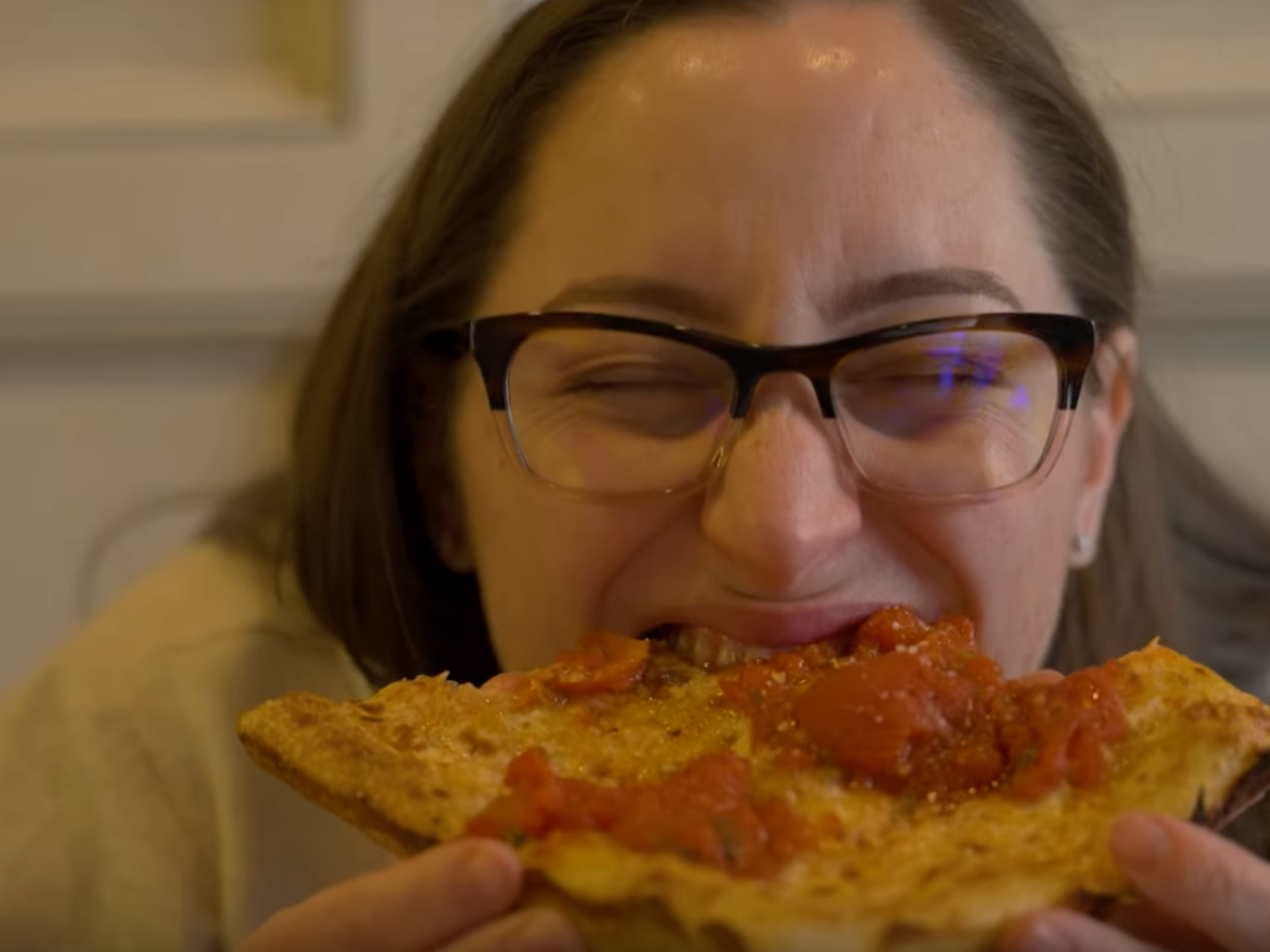 a woman eating a slice of pizza