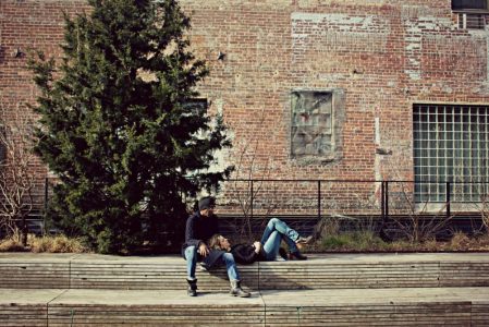 two people sitting on a bench on the high line