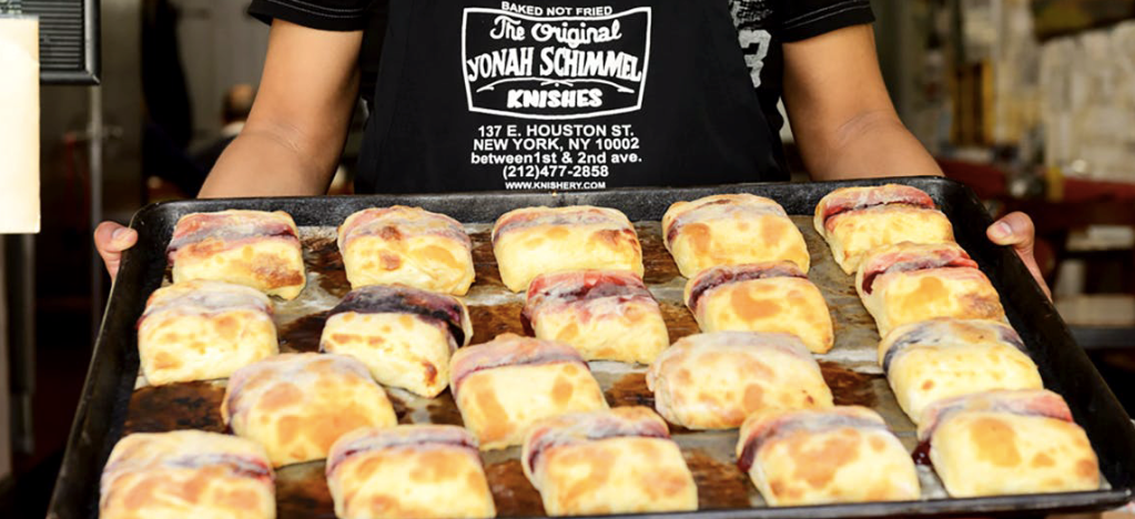 a person holding a tray of food