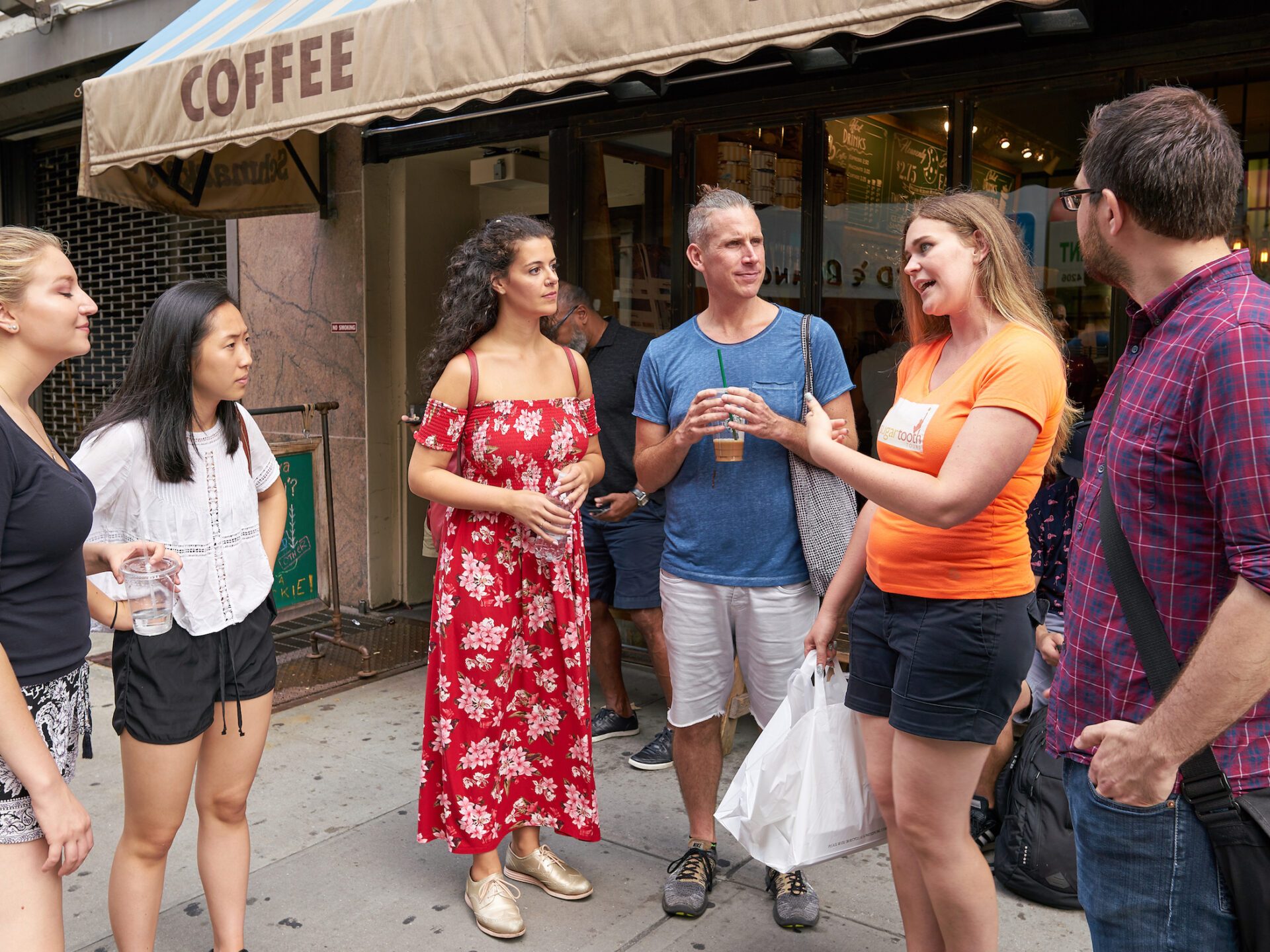 a group of people standing in front of a building