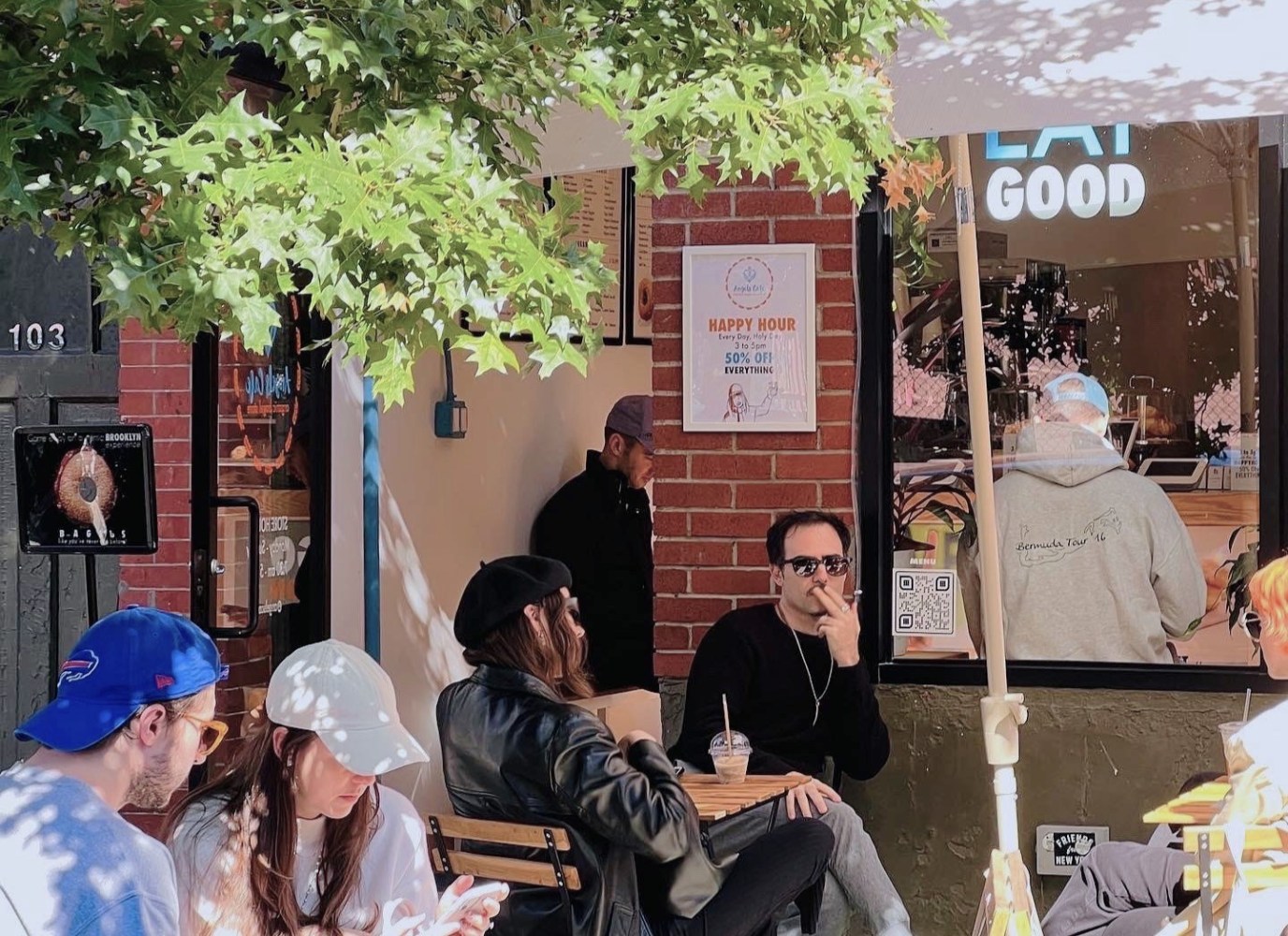 a group of people sitting in front of a building