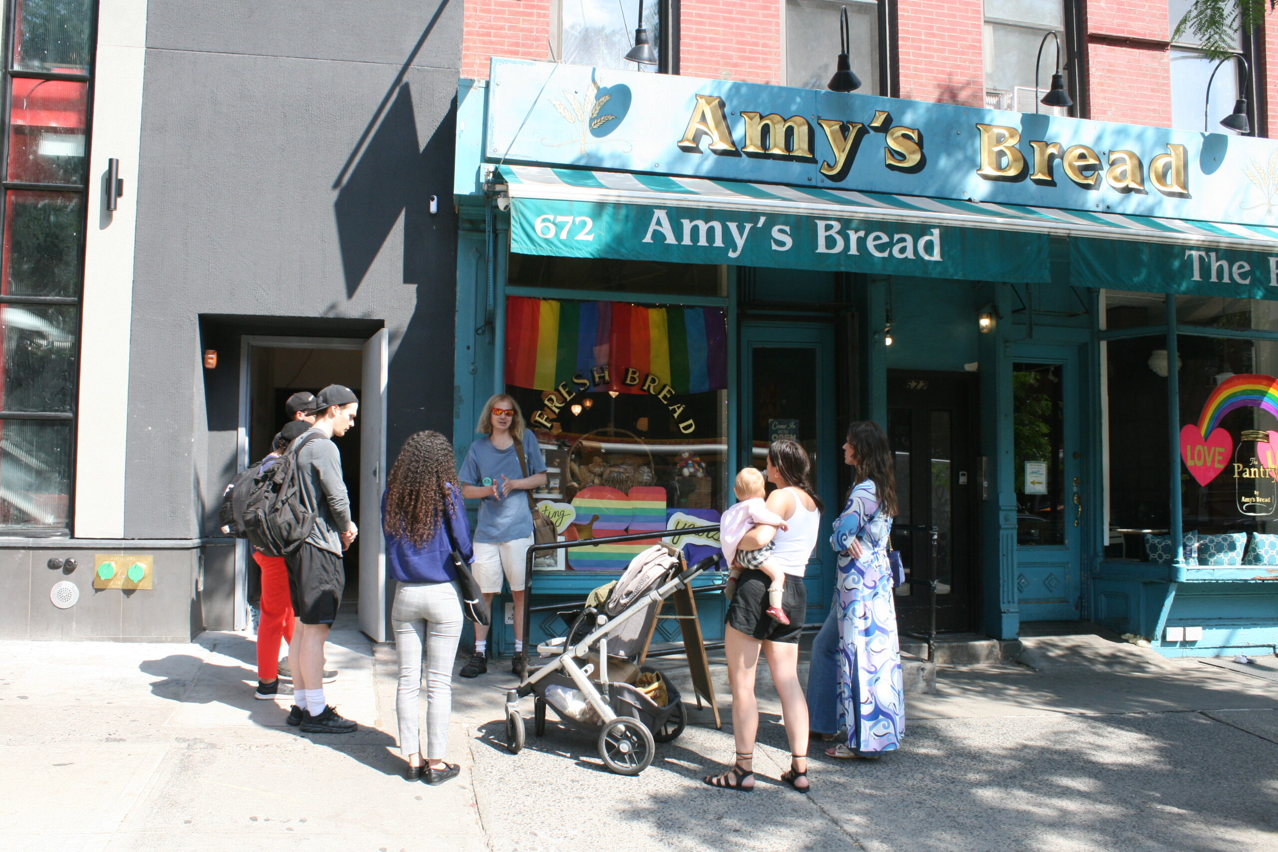 a group of people standing in front of a store