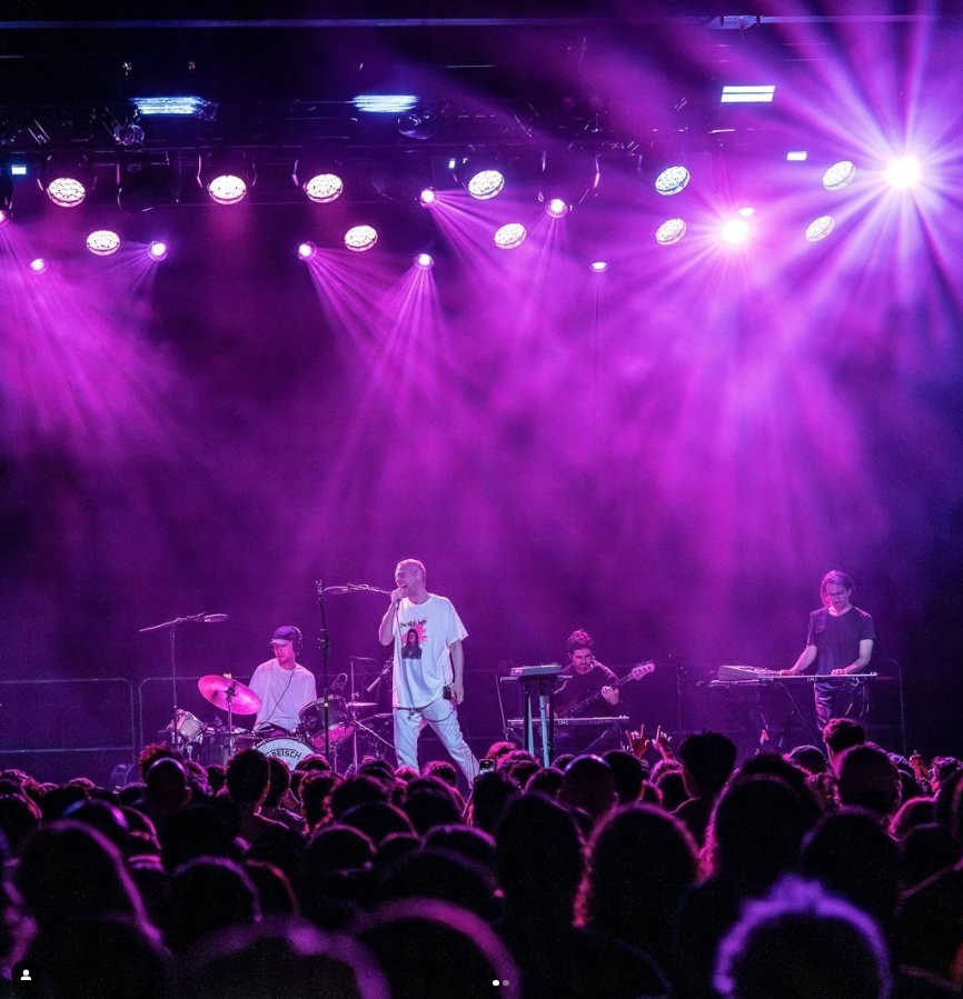 a group of people on a stage in front of a crowd