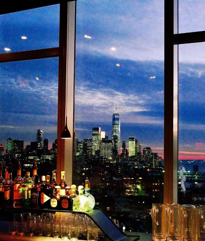 a view of a city at night in front of a window